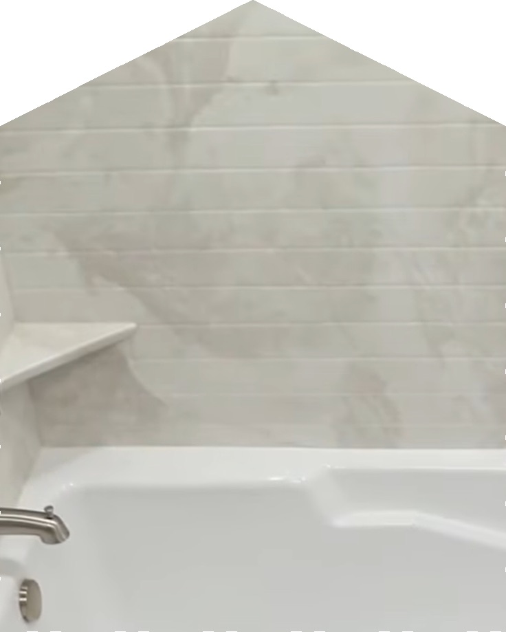 Light marble-look plank wall surrounding a tub with a corner shelf